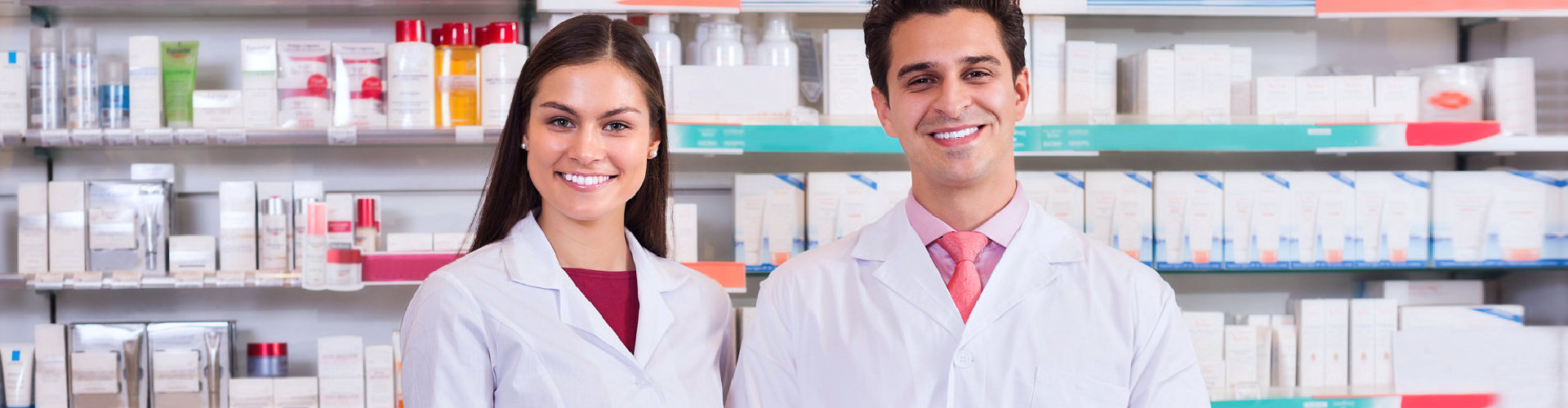female and male pharmacists smiling